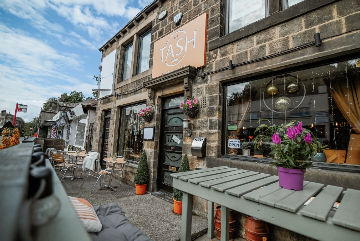 The Tash's stone shopfront and outdoor seating on Harrogate Road, Rawdon